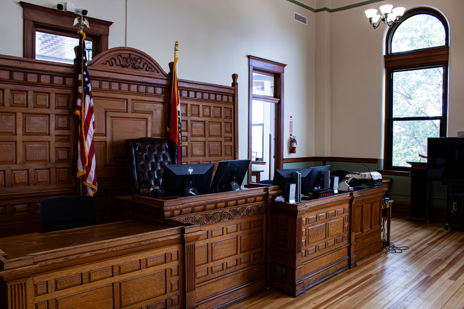 Interior of a U.S. district courthouse — judge's bench and witness stand