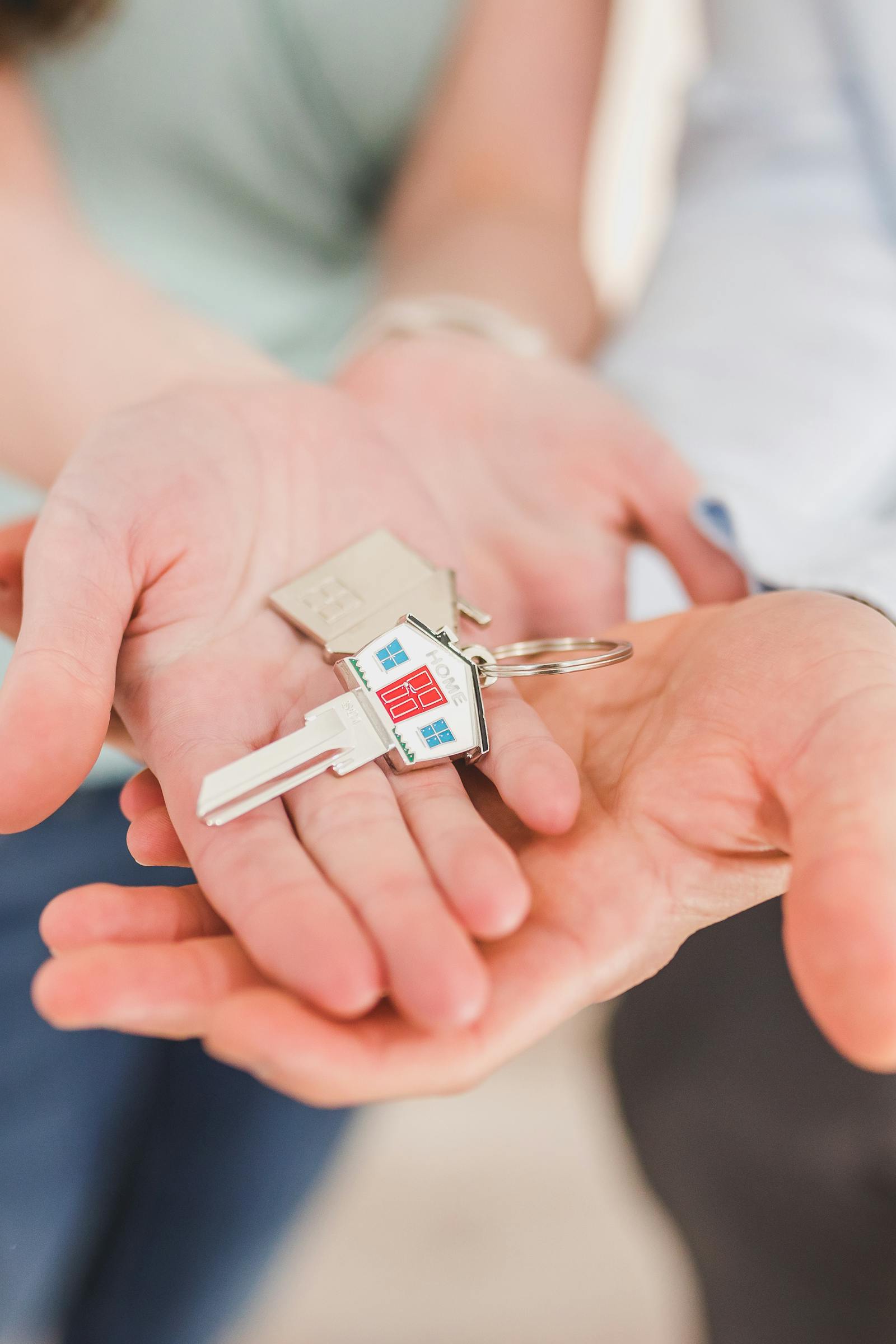 House keys held in an open hand, symbolizing transfer of real estate to a charitable organization